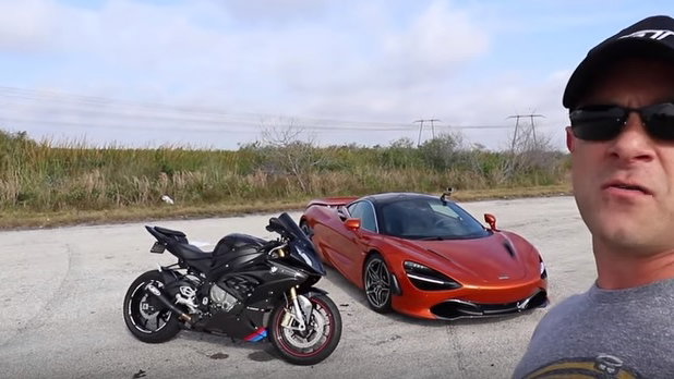 Motorcycle and car on track 